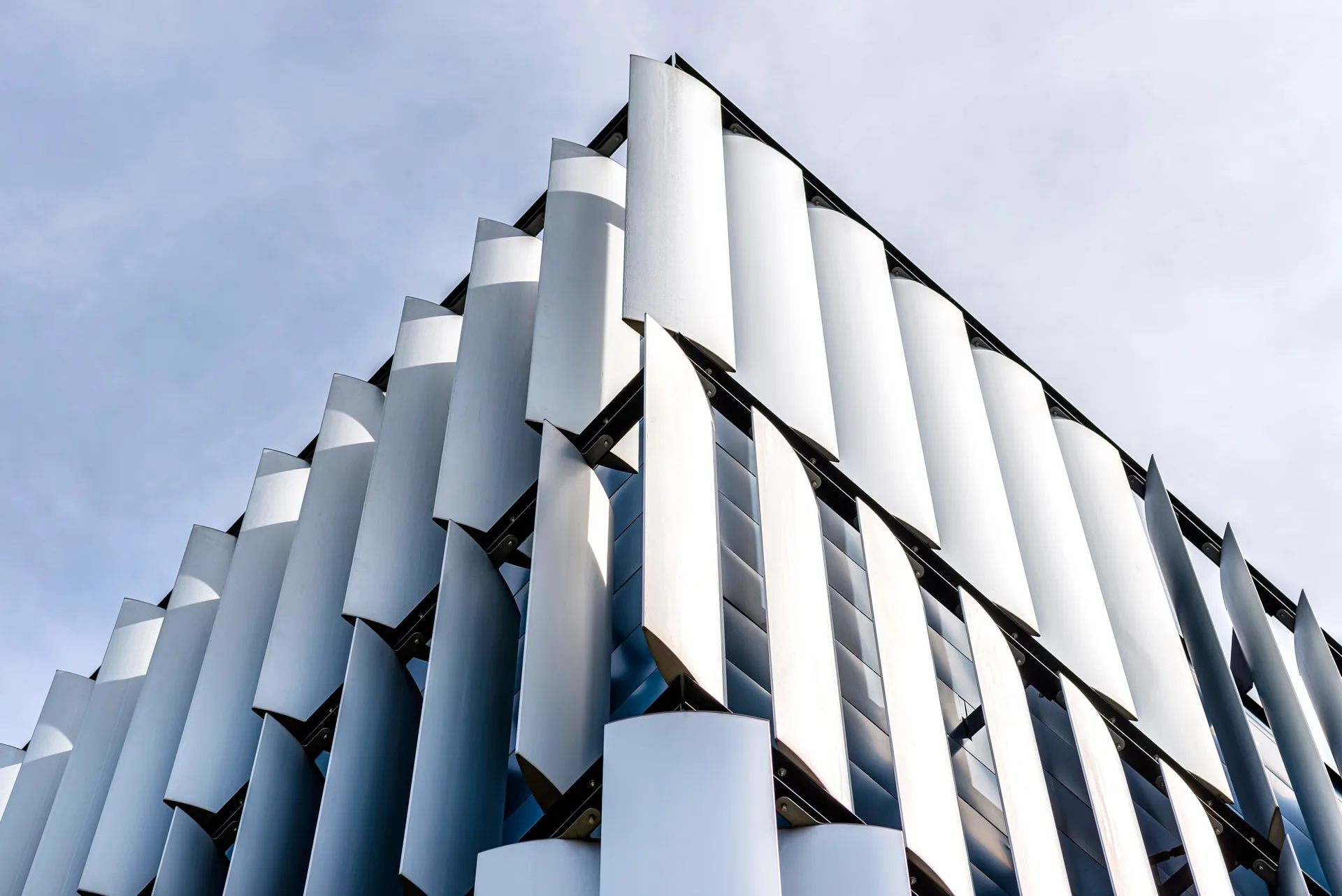 The facade of a modern building with an innovative facade made of automatic, movable blinds.